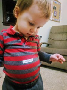 Toddler looking at his tummy