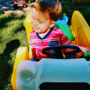 Toddler sitting in play bus