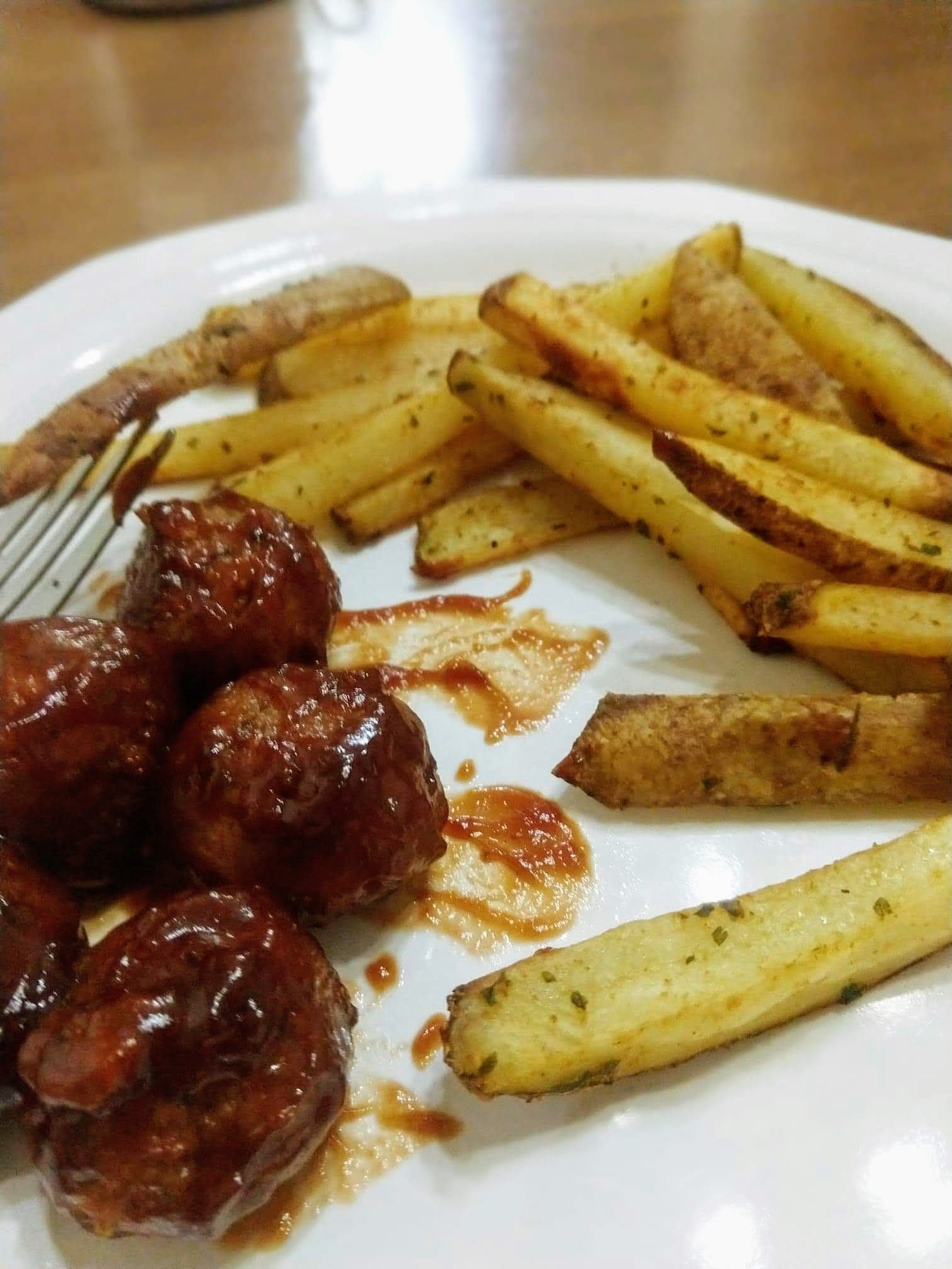 Meatless meatballs plated with homemade french fries