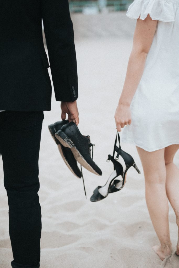 InstaCrime: An Alleged Midwest Wedding Photography Scam 7 bride and groom walking away from camera, holding their shoes