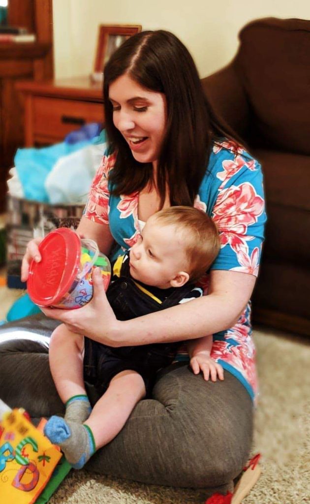 How To Throw A First Birthday Party For Less Than $100 8 woman and baby opening presents at first bday party