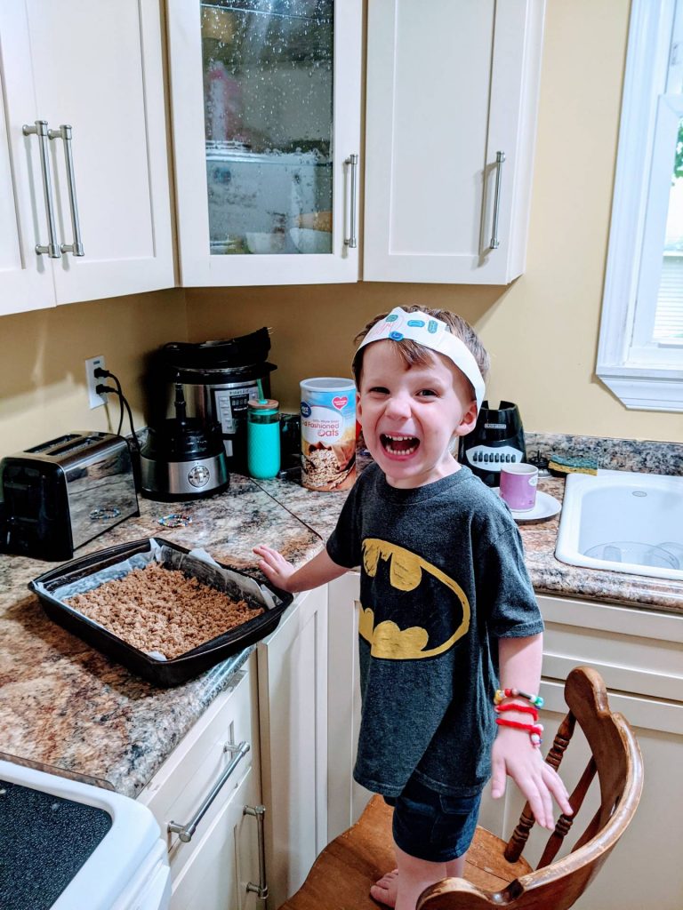 Kid making healthy after school snack of homemade granola bars