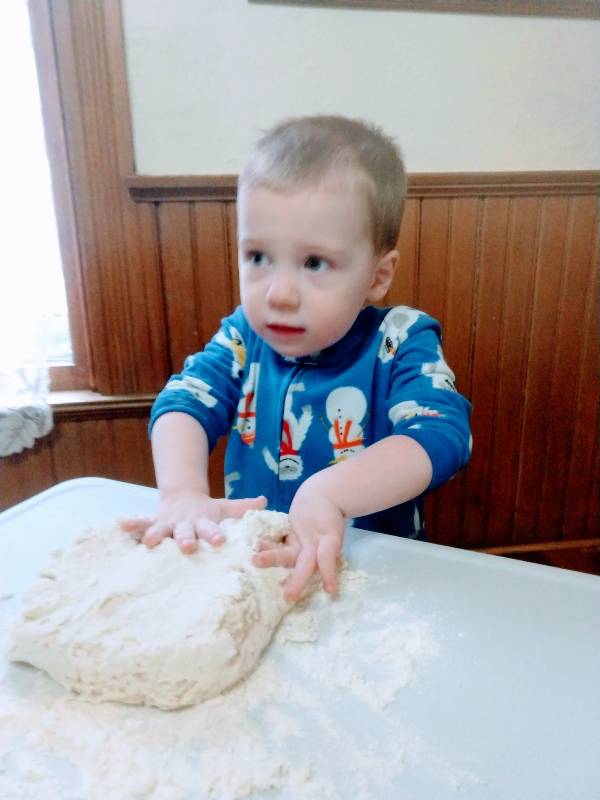 autistic toddler kneading homemade play dough